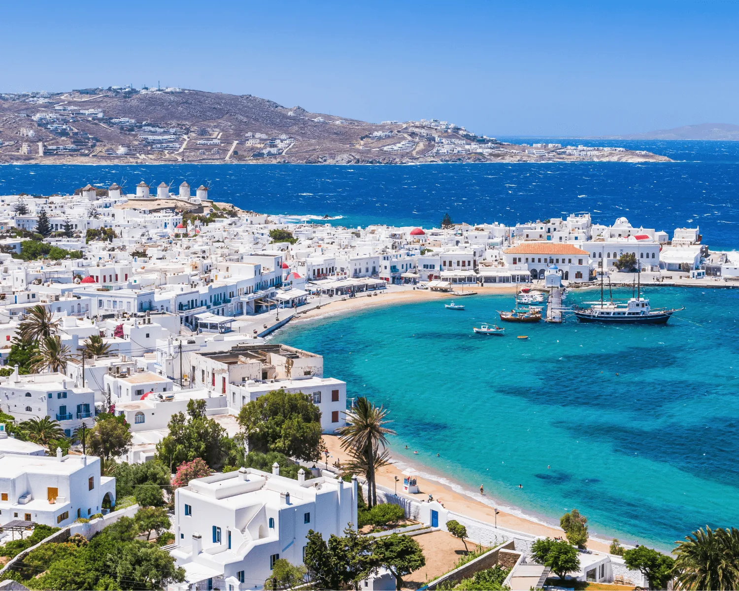 Mykonos with white houses and turquoise Aegean water